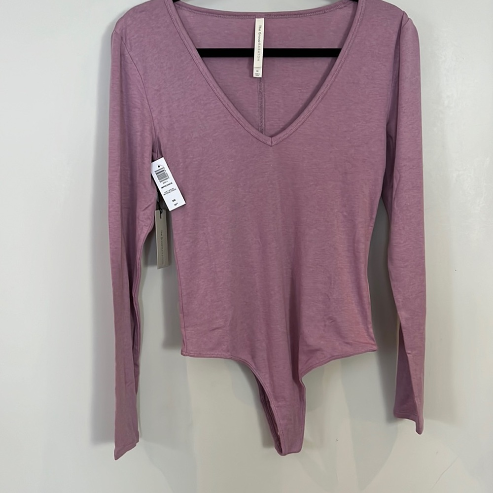 The group Babaton pink v-neck bodysuit. Medium.